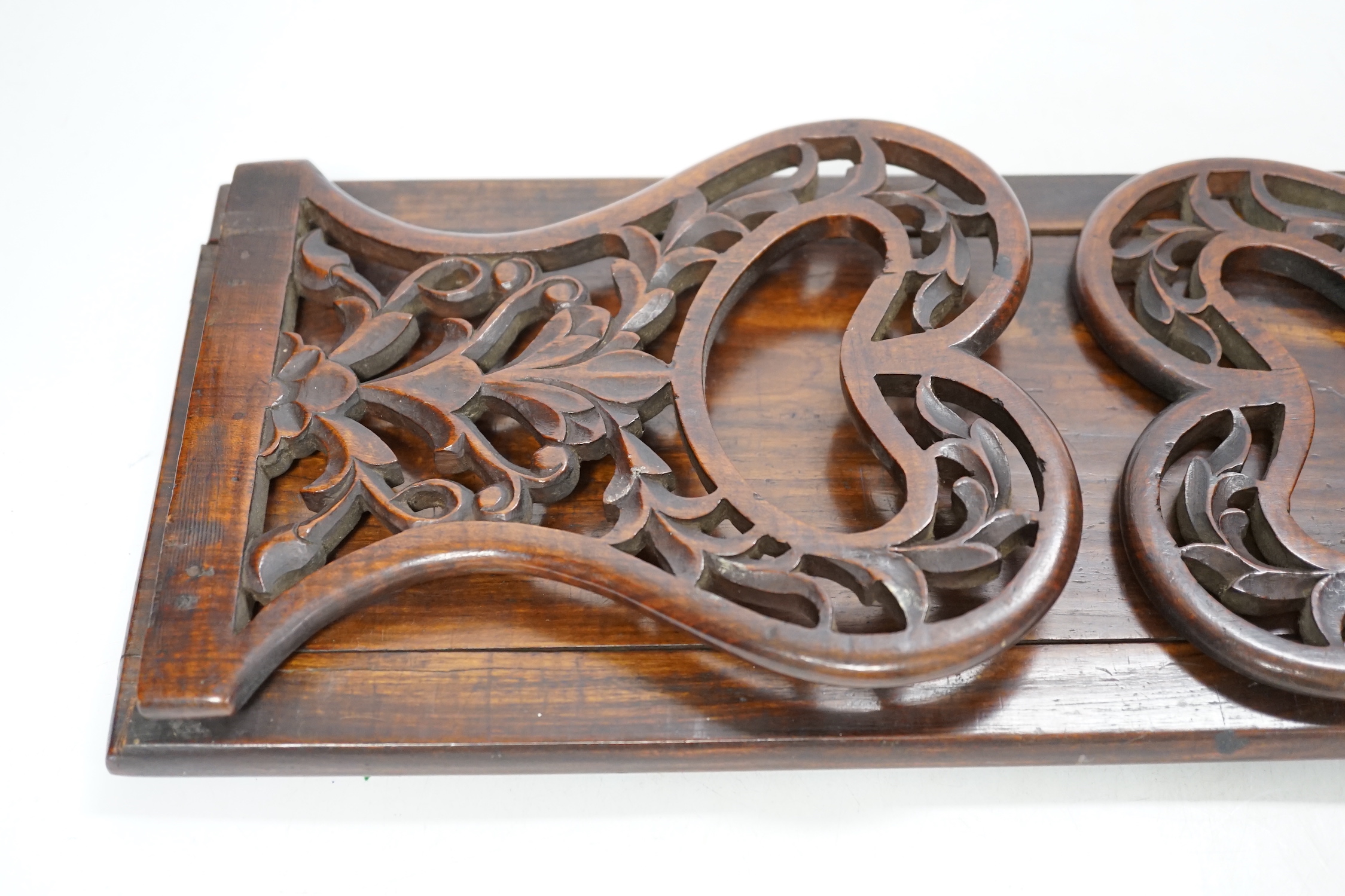 A 19th century rosewood book slide with fretted sides, base 39cm wide